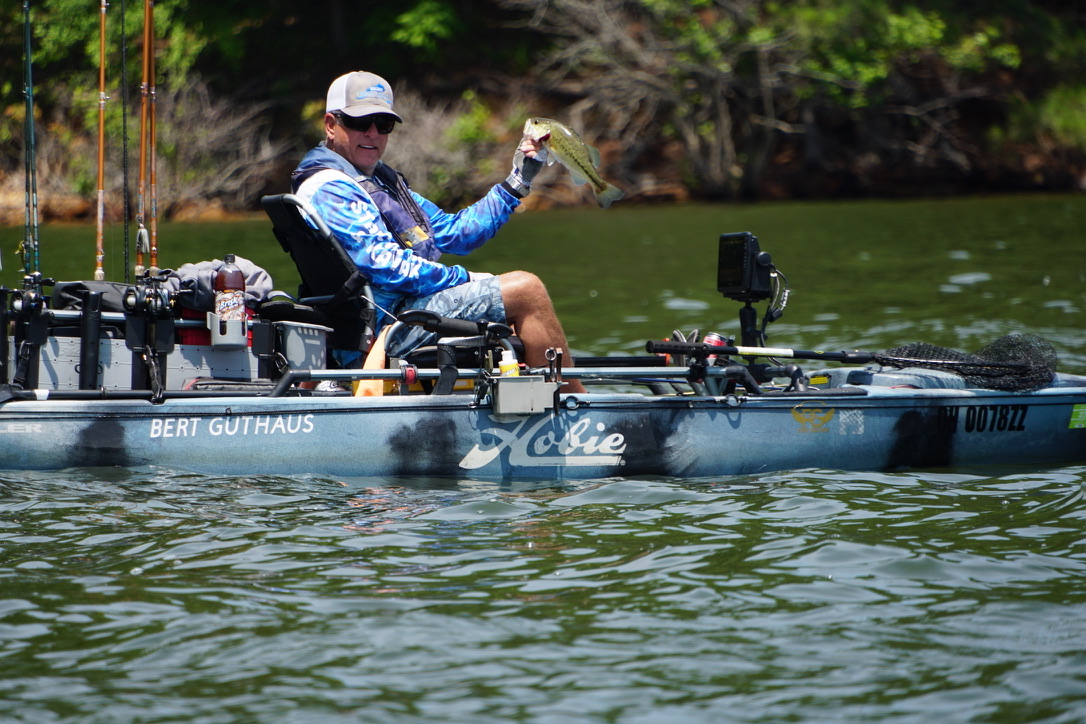 CKF angler displaying a bass on the water